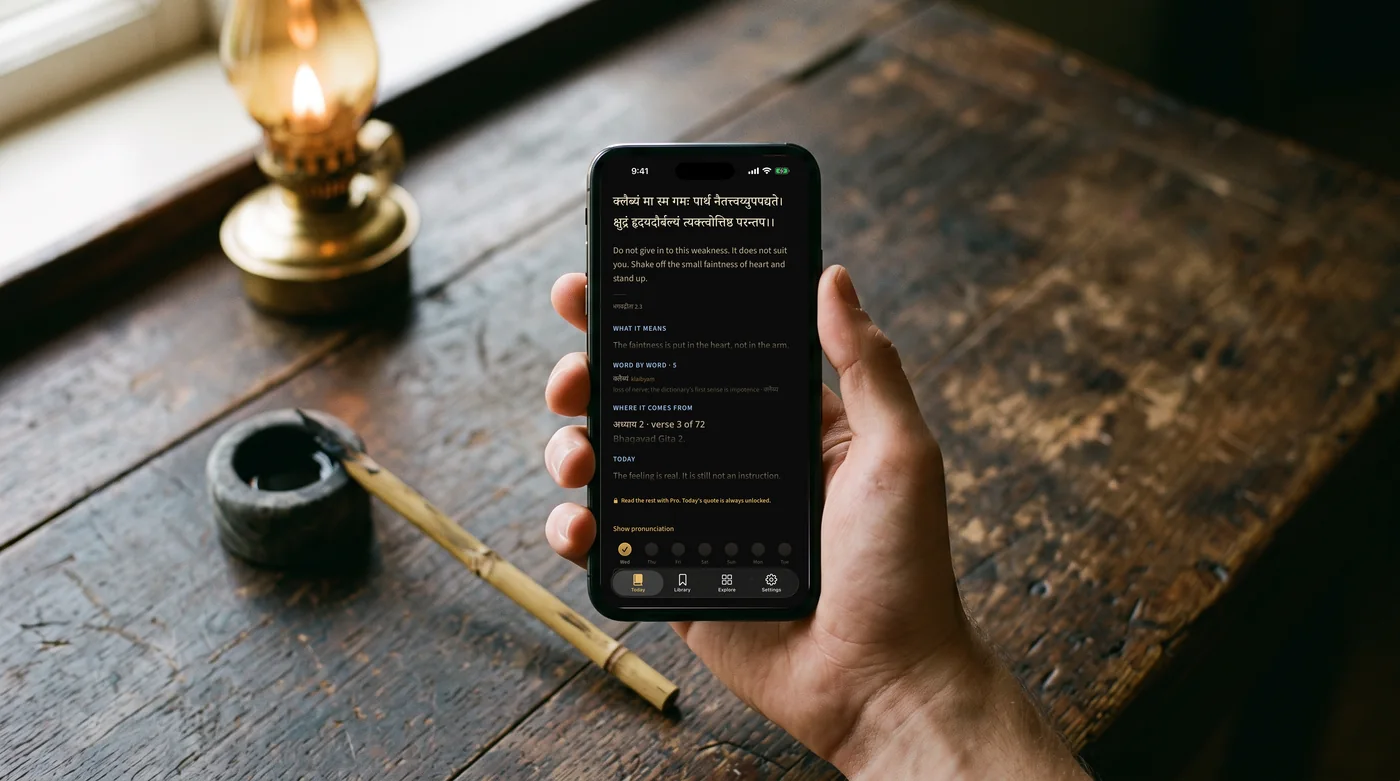 The app open on a phone held in the hand, over an old writing desk.